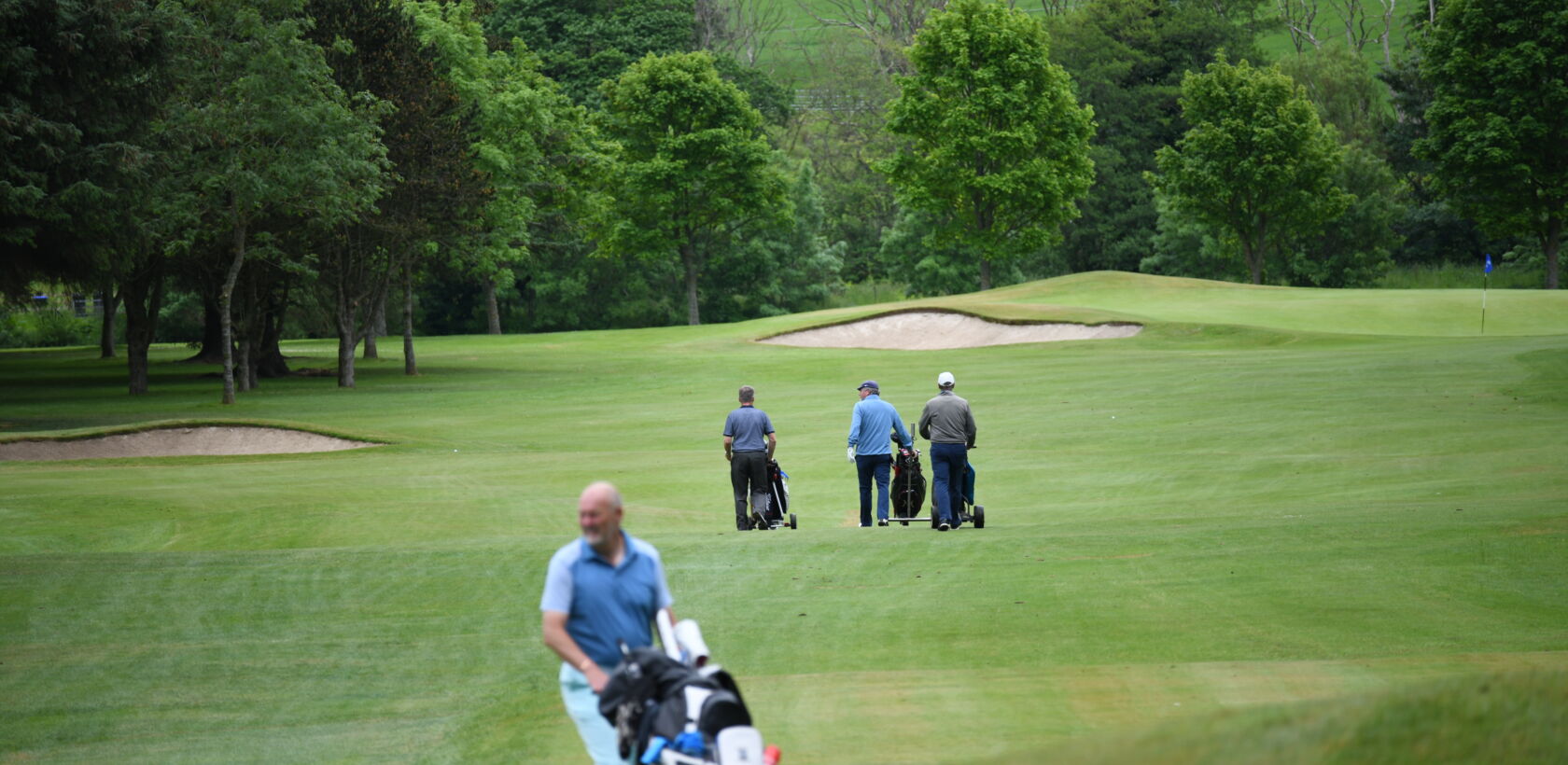 Golfers enjoying a relaxing game at Duff House Royal Golf Club