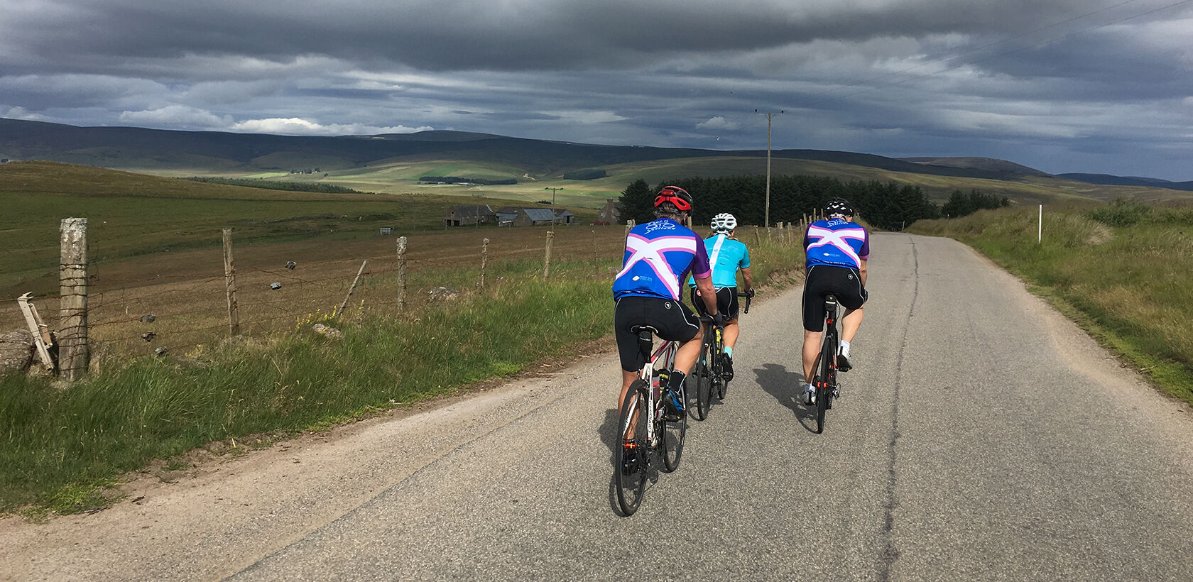 Three road cyclists cycling The Cabrach