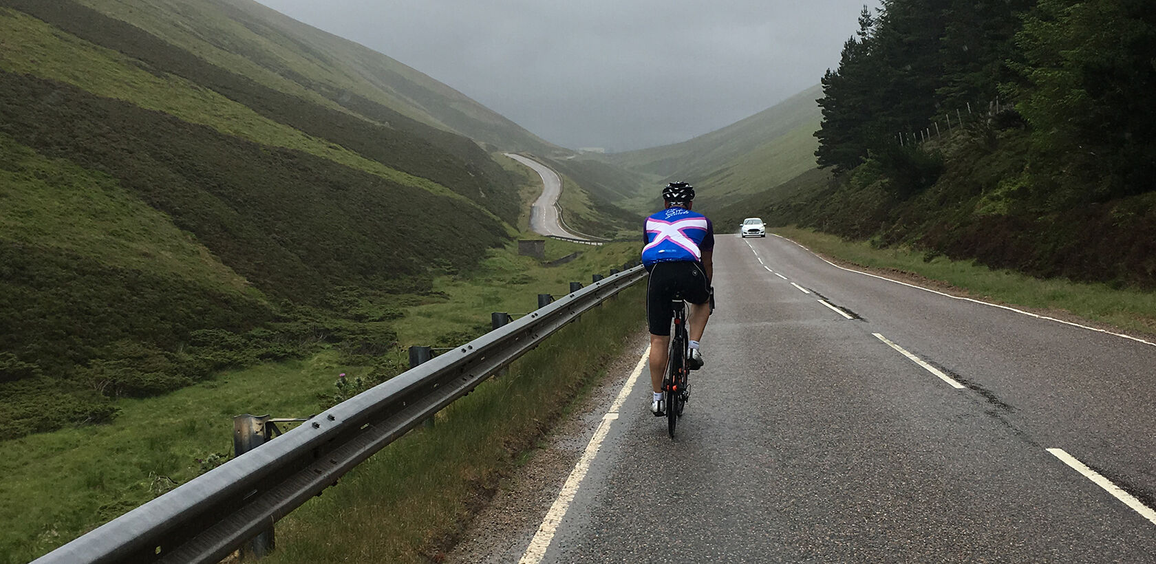 Cyclist cycling up the Lecht from the north side