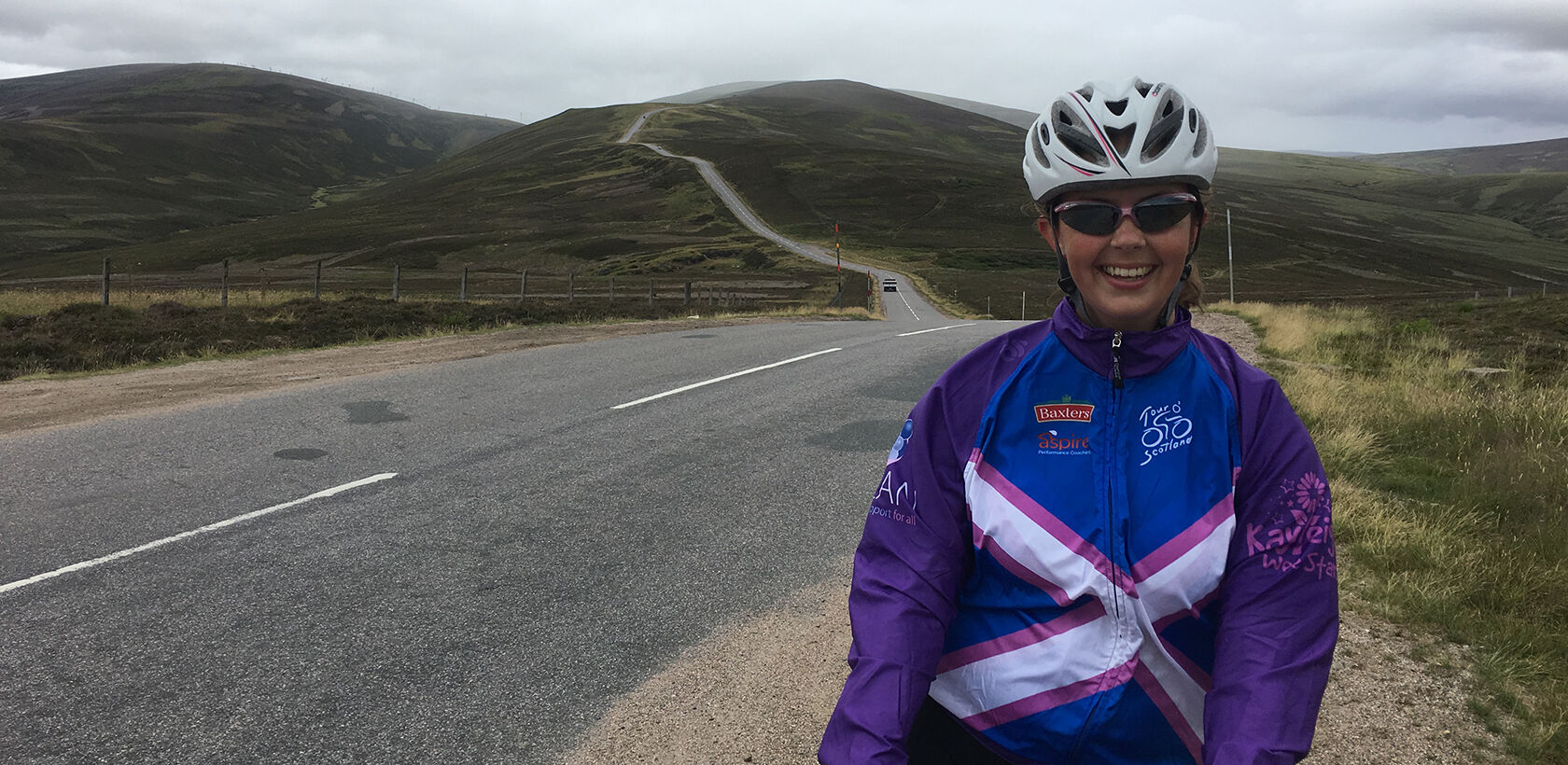 Female Cyclist with The Lecht in background