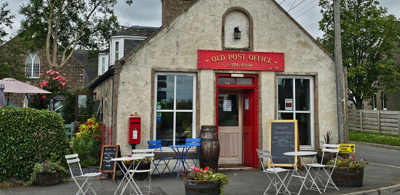 Post office converted to a tearoom with tables and chairs outside